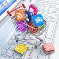 Store of laptop software. Apps icons in shopping cart. Royalty Free Stock Photo