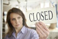 Store Owner Turning Closed Sign In Shop Doorway Royalty Free Stock Photo