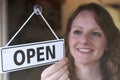 Store Owner Turning Open Sign In Shop Doorway Royalty Free Stock Photo