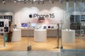 Store selling Apple products with large sign advertising for iPhone 15.