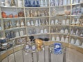 Store shelf with display of various glass items, jars and decorative bottles Royalty Free Stock Photo