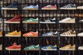 Store shelves with Adidas sneakers, including Gazelle, Campus, Stan Smith