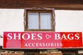 Store sign for shoes, bags on old house window Royalty Free Stock Photo