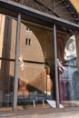 Store Window of a Luthier`s Shop: Handmade Violins on Display and Reflection of the Cathedral of Cremona in the Shop Window,