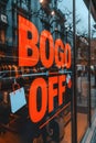 A store window with a sign that says boog off, AI Royalty Free Stock Photo