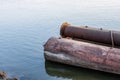 Stored rustic old dredging pipes on the river water Royalty Free Stock Photo
