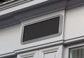 Storefront on a grey shop frontage Mockup. Empty store brand signboard frame in street