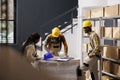 Storehouse employees preparing order and chatting in storage room