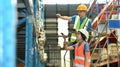 Storehouse employees workers in hardhats and and vests working together in warehouse. Logistics, and manufacture Royalty Free Stock Photo