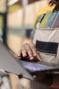 Storehouse manager looking at cargo stock on laptop