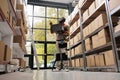 Storehouse manager looking at merchandise boxes