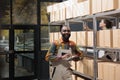 Storehouse manager standing near shelves full with boxes