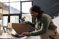 Storehouse supervisor checking online orders on laptop