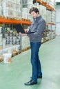storeman using laptop in warehouse