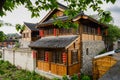 Storied tile-roofed timberwork buildings in cloudy spring after