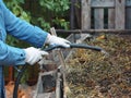 Storing organic fertilizers in compost heaps.A woman sprinkles a manure heap from waste and animal manure with water for early Royalty Free Stock Photo