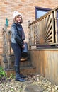 Happy woman collecting fuel for a multi-fuel stove 2, during a cold winter. Royalty Free Stock Photo