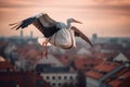 Stork delivery over rooftops of the city. Generative AI image. Royalty Free Stock Photo