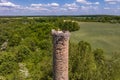 a stork hatches its chicks in nest on top of tall old brick chimney