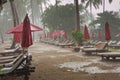 Storm on the beach, heavy tropical rain in tourist hotel resort, bad weather