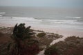 Storm on the beach. The seas are raging and the skies show the tropical storm as the power of nature is demonstrated. palm tree pu