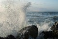 The storm begins at sea. the waves hit the rocks and the water is scattered. a sky covered with black clouds Royalty Free Stock Photo