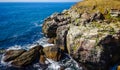 Storm at Black sea. Big waves break on the rocky shore, white foam on the water Royalty Free Stock Photo