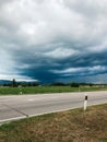 A storm is brewing in the sky above a road Royalty Free Stock Photo