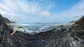 Storm on Castelejo beach with black schist stone cliffs and yelloy sand (Algarve, Portugal