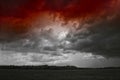 Storm cloud over yellow green fields forests and hills Royalty Free Stock Photo