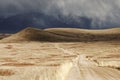 Storm Cloud Passing Through a Barren Mountain Land