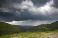 Storm clouds above meadow with green grass Royalty Free Stock Photo