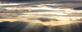 Storm clouds, colorful, heavy, fluffy on the sky background, at sunset, sunbeams through them.