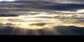 Storm clouds, colorful, heavy, fluffy on the sky background, at sunset, sunbeams through them.