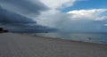 Storm clouds cover the beach over pier