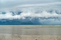 Storm clouds forming over a beach. Dense, towering raincloud before the storm Royalty Free Stock Photo