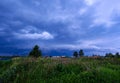 storm clouds forming over green meadow pastures Royalty Free Stock Photo