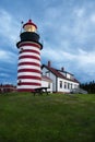 Storm Clouds Gather Around Red and White Striped Lighthouse in New England Royalty Free Stock Photo