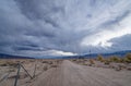 Storm clouds gather over a dirt road in the desert in western Nevada, USA Royalty Free Stock Photo