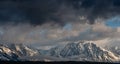 Storm clouds gathering over the snow covered Tetons in Wyoming. Royalty Free Stock Photo