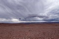 Storm clouds in the landscape of the Atacama Desert. The rocks of the Mars Valley Valle de Marte and Cordillera de la Sal, Royalty Free Stock Photo