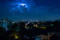 Storm clouds with lightning strike bolts passing over night city Royalty Free Stock Photo