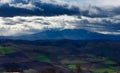 Storm clouds mountains fields panoramic sun ray cima innevata Royalty Free Stock Photo