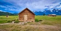 Storm clouds with outhouse, pumphouse and granary. Mormon Row, Grand Teton National Park