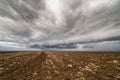 Storm clouds over arable land Royalty Free Stock Photo