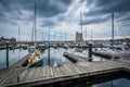 Storm clouds over docks and boats in Harbor East, Baltimore, Mar Royalty Free Stock Photo