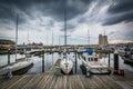 Storm clouds over docks and boats in Harbor East, Baltimore, Mar Royalty Free Stock Photo