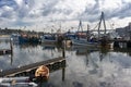 Storm clouds over fishing boats harbor