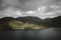 storm clouds over the forest and the broken lake