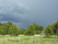 Storm clouds over forest and field Royalty Free Stock Photo